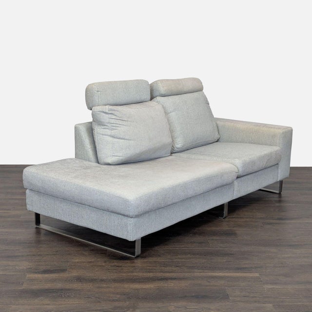 Upgrade your living space with this BoConcept sectional. Featuring a sleek light gray fabric, sturdy metal legs, and...
