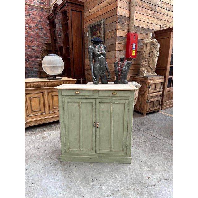 This antique sideboard with a distressed finish has been fully restored. It features a raw wood top and a green-distressed...