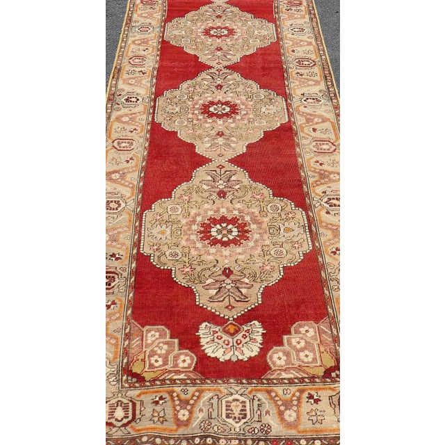 Measures: 3'10 x 20'6. Vintage Turkish Oushak Runner Featuring Red Field and Bold Medallions with Tan. Keivan Woven Arts /...
