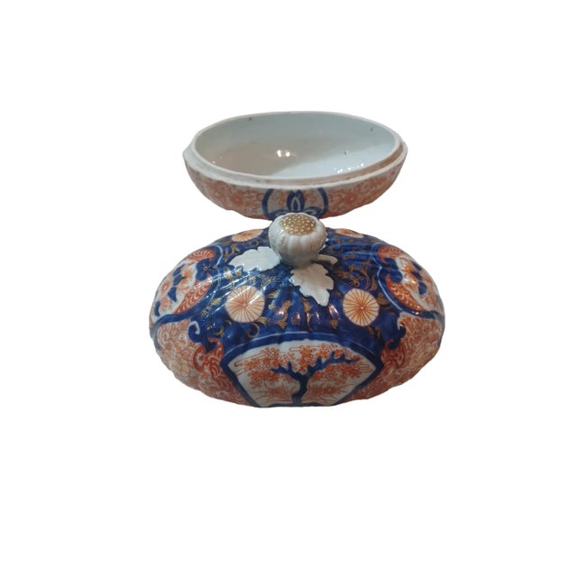 Vintgae ceramic chinoserie Asian Lidded dish. Dish is oblong with blue and orange decorative and handpainted gold gilt.