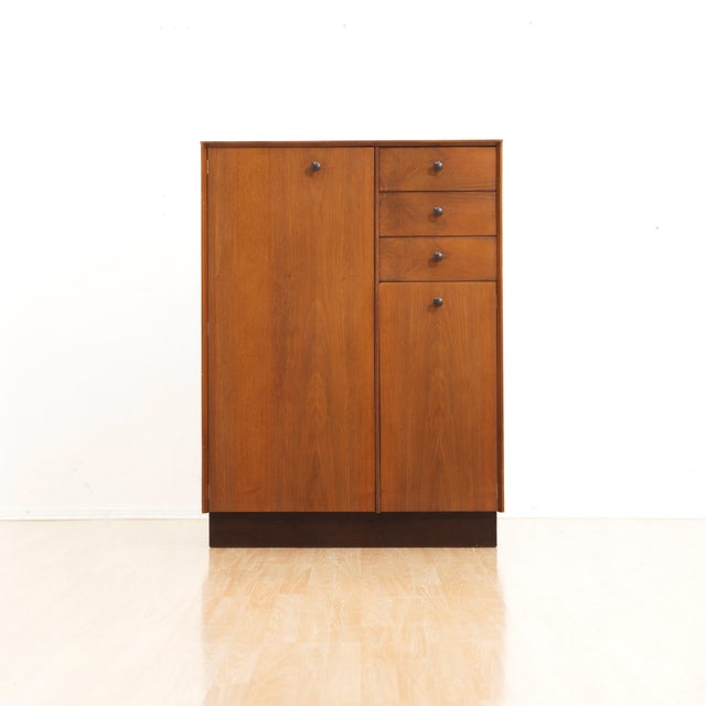 A beautifully proportioned mid-century gentleman's wardrobe, crafted in richly figured African mahogany and designed to...