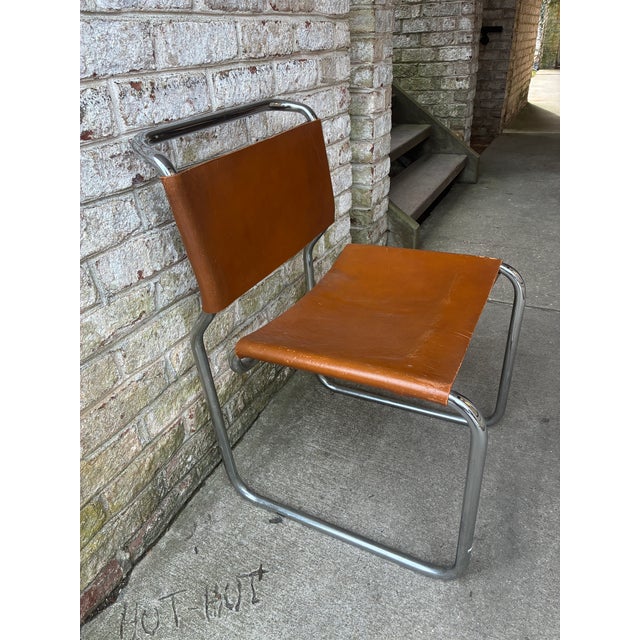 This brown leather and chrome chair by Greek designer Nicos Zographos is the perfect sculptural piece for any space....