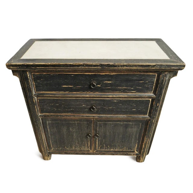 Black aged finish rustic wood nightstand with contrasting cream marble inset top. Features two drawers with cabinet space...