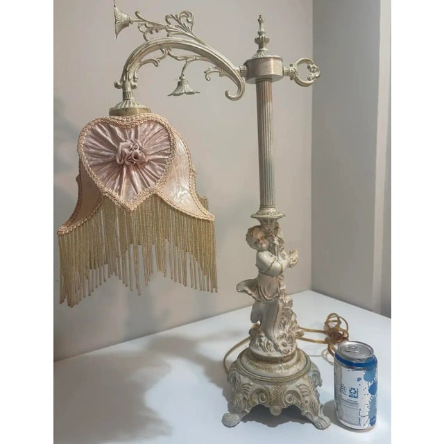 Romantic pair of vintage Rococo Revival boudoir lamps featuring sculptural cherub (putti) bases, fluted columns, and...