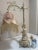 Romantic pair of vintage Rococo Revival boudoir lamps featuring sculptural cherub (putti) bases, fluted columns, and...