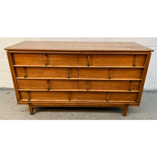 This vintage mid-century modern double dresser by J.B. Van Sciver Co. Furniture, featuring a warm walnut finish and...