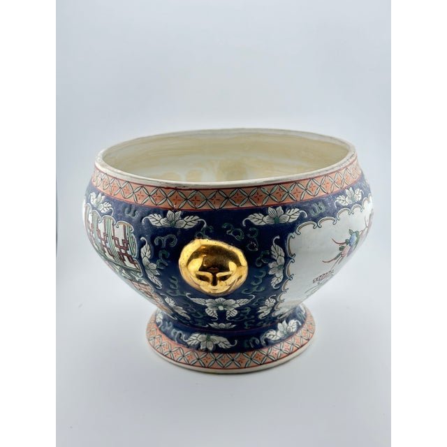 Chinese jardiniere/planter decorated in the Famille Rose style. The planter has a raised texture and pattern along the...