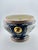 Chinese jardiniere/planter decorated in the Famille Rose style. The planter has a raised texture and pattern along the...