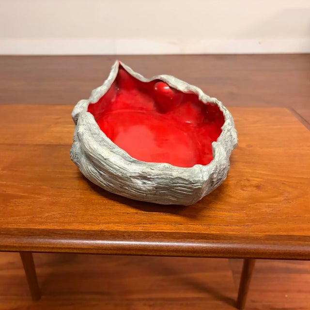 An eye catching sculptural ceramic centerpiece bowl featuring a beautifully modeled driftwood inspired exterior and a rich...