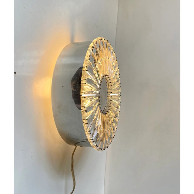 Ornate wall sconce or Flush mount from Glashütte Limburg in Germany. Made during the 1960s. Its made from cut faceted...