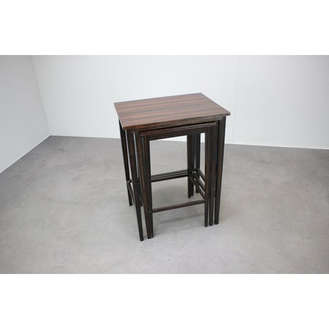Elegant set of three nesting tables manufactured in Czechoslovakia during the 1950s. Their clean architectural lines and...