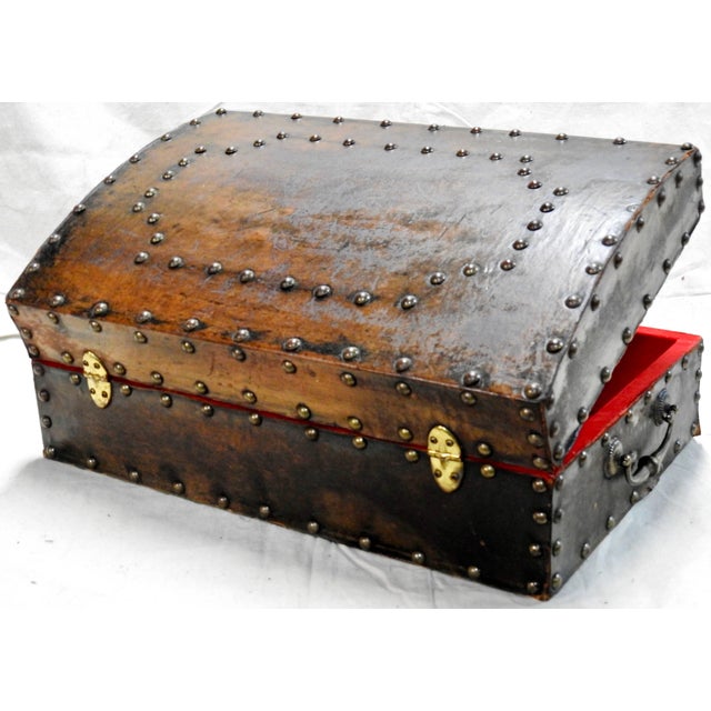The hammered bronze tacks make a statement on this classic leather on wood box from the late 1800s. It has a pair of...