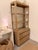 This is a substantial, architectural etagere style storage cabinet with a warm dark blonde wood wire brush finish and...