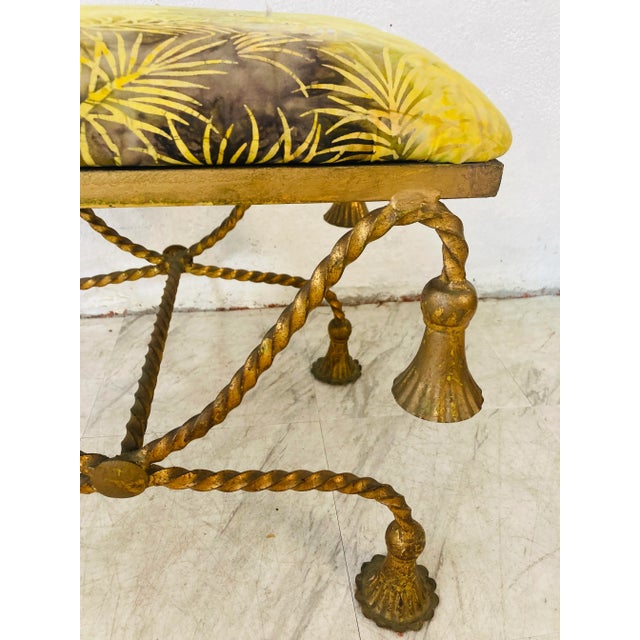 Gold tassel iron bench, this Italian beauty has had a cushion added! We believe the fabric is an original batik!