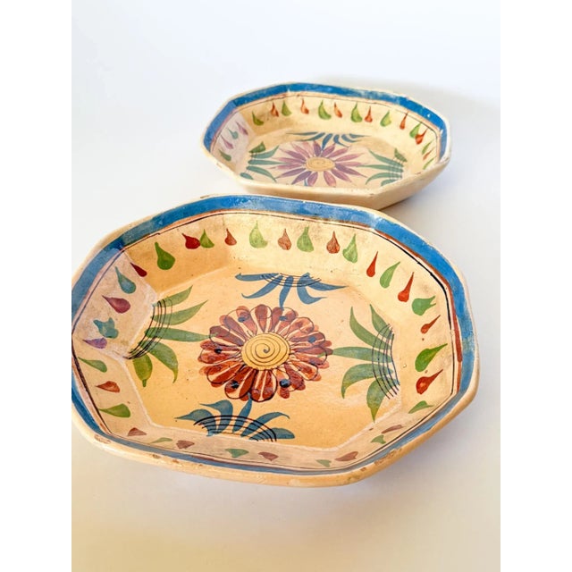 This set is really beautiful with a creamy yellow background and a great flower and border motif in shades of rust, denim...