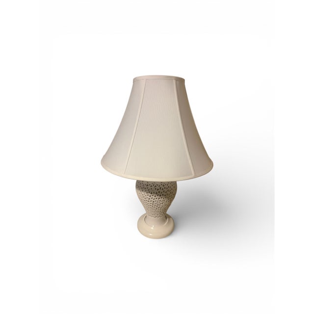 Beautiful pair of early 19th century Japanese ceramic urn table lamps in white. Cherry blossom tree motif. The height is...