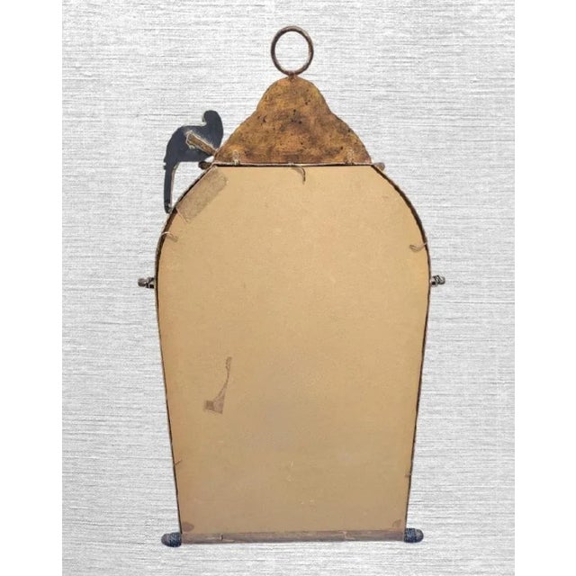 A beautiful vintage bird cage wall mirror by Horchow. The mirror features an antique brown and copper mottled finish with...
