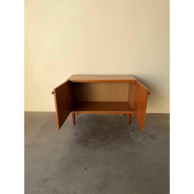 Classic Danish Mid-Century Modern teak cabinet from the 1960s, featuring clean Scandinavian lines, warm teak grain, and...