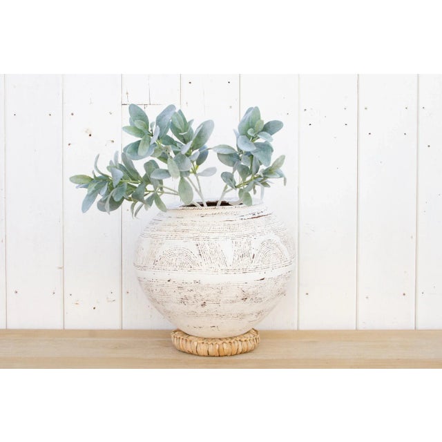 An original Nupe clay pot from Nigeria. This beautiful tribal African Terracotta pot of spherical shape has a custom...