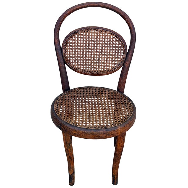 Victorian style child size Thonet number 15 oak side chair features an elegant, sculptural frame crafted from warm-toned...