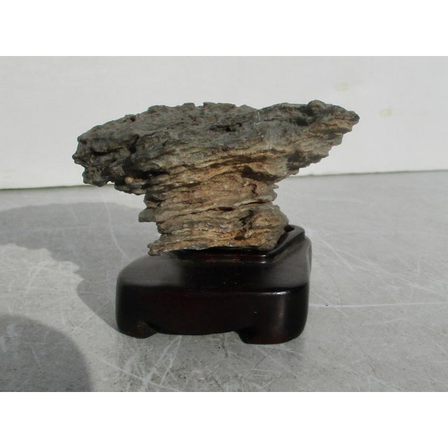 Gtratified Gongshi, scholars' stone mounted in a fine rosewood stand. Stark and severe layers worn by wind and weather...