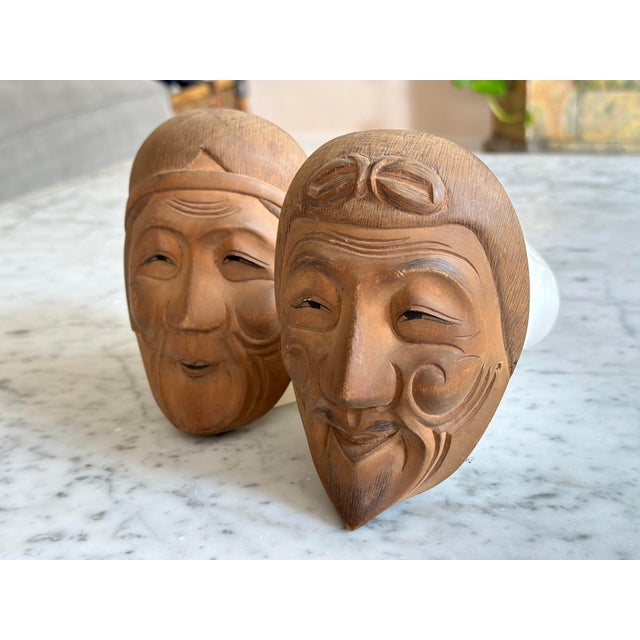 This exquisite pair of Japanese Kyogen masks, crafted around the 1950s-60s, showcases the art of traditional Japanese mask...