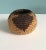 Small tan and brown Southwest Style round woven decorative basket. Size: 5.5"D x 3.5"H.