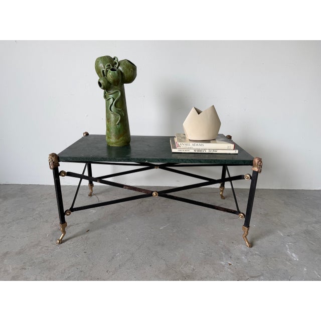 Elegant Hollywood Regency / Neoclassical style cocktail table featuring a rich green marble top with beautiful natural...