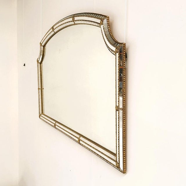 A striking large vintage spanish mirror dating from circa the 1970s, featuring an elegant architectural silhouette and...