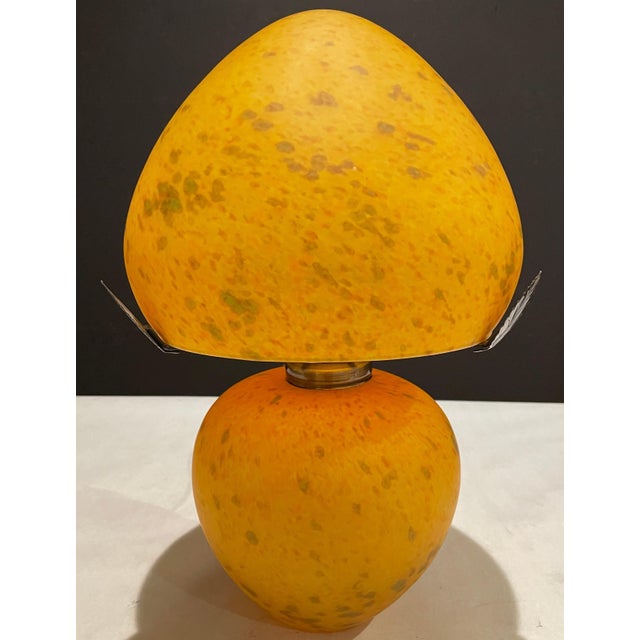 Mottled orange mouth blown art glass lamp and shade. Original makers label affixed to shade. French maker.