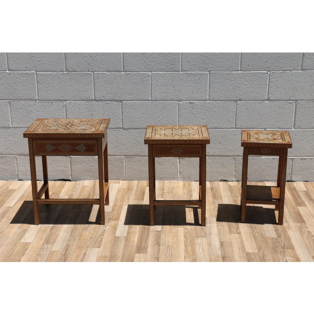 Beautiful vintage set of three handcrafted nesting tables featuring intricate Moorish-style geometric inlay work...
