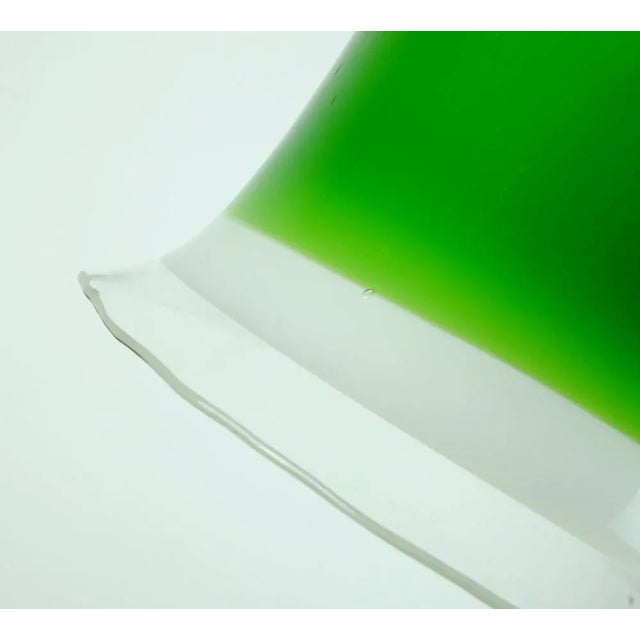 Hanging lamps from the 1970s. Made by Peill & Putzler, model no. Ah 191. The umbrella is made of glass in green, white and...