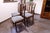 Set of four Art Nouveau dining chairs from the early 20th century. Crafted from solid wood, these chairs feature elegantly...