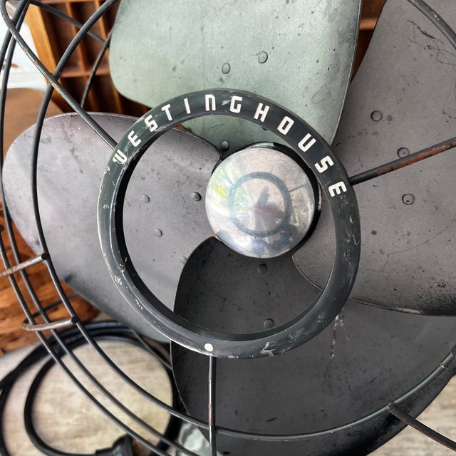 This Westinghouse desk fan exudes mid-century industrial charm. A fully functional piece with a black metal frame and...