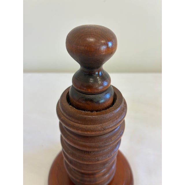 A vintage wooden napkin ring set complete with matching stacked holder stand. The turned wood post and round base create...