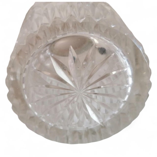 A vintage cut-pattern glass vase, dating from the mid-twentieth century, featuring an ornate silver-toned metal mount with...