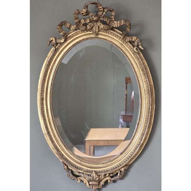 An elegant French oval mirror, crafted in the second half of the 19th century, during the Napoleon III era, in the Louis...