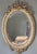 An elegant French oval mirror, crafted in the second half of the 19th century, during the Napoleon III era, in the Louis...