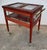 A charming 1950s wood trolley with brass accents and glass panels, featuring a lift-up display case and a side handle....