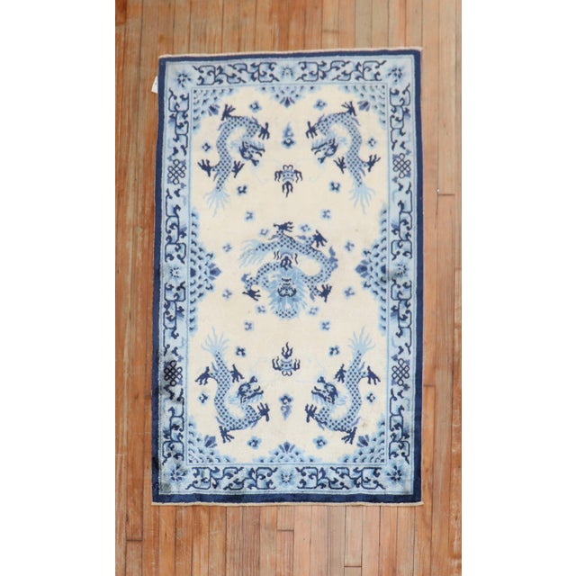 A late 20th-century Chinese Silk rug in beige, light blue and navy Measures: 3' x 4'11''.