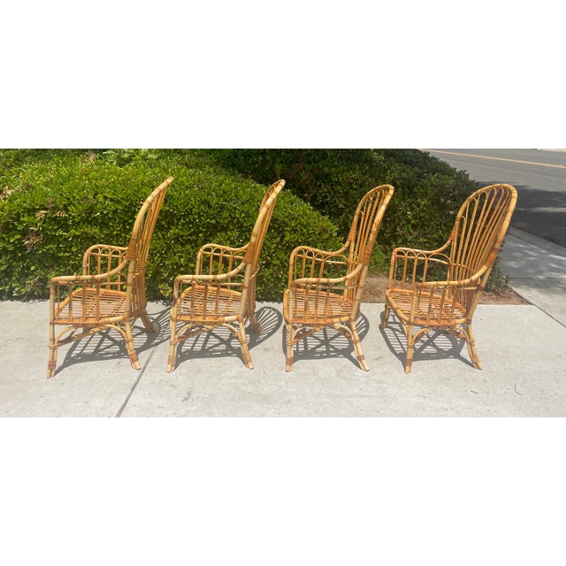 Gorgeous set of 4 vintage rattan Windsor style armchairs. They are high backed with a tall profile at 47” height. The...