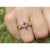 Marquise cut natural pink Sapphire adorned with natural white diamond side-stones. Gemstones are mounted in a textured 14k...