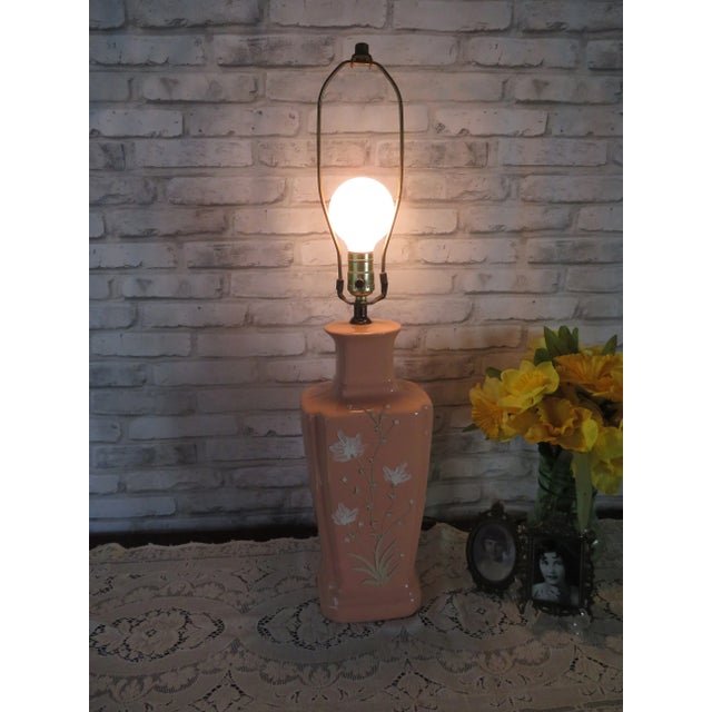 This is a beautiful vintage lamp! It is a porcelain pink glazed table lamp with beautiful design created by an unknown...