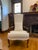 Gorgeous pair of elegantly carved solid wood and cream upholstery high back arm chairs. Features beautifully carved solid...