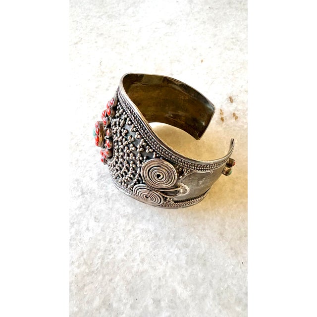 Ornate ethnic cuff bracelet features intricate silver granulation and filigree work inlaid with red coral and turquoise...