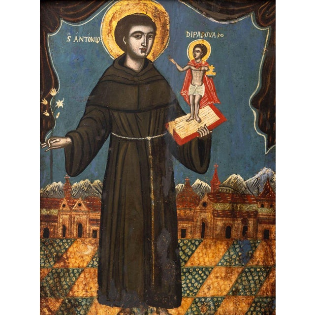 Italian Icon of Saint Anthony of Padua, Oil on Panel, 18th century, holding a lily and book with baby Jesus both with gilt...