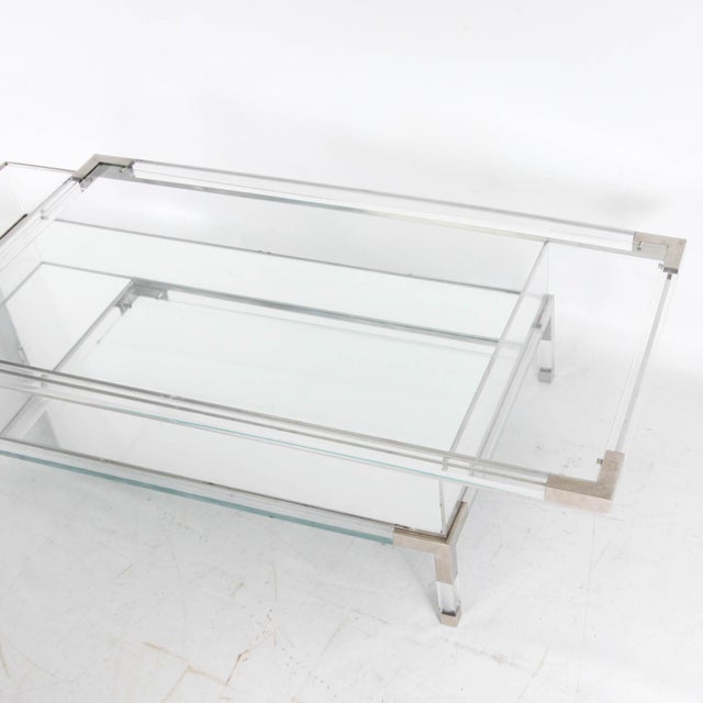 Beautiful 1980s display coffee table. Featuring a sliding top, this acrylic and chrome table is very practical for...