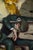 In "Something in the Way," a figure slumps in a chair, embodying a mood of introspection and weariness. The rich,...