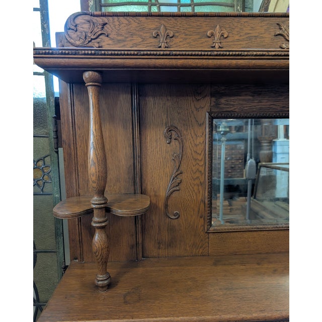 A beautifully crafted antique oak fireplace mantel from to C.B. Atkin Co., dating to the late 19th or early 20th century....