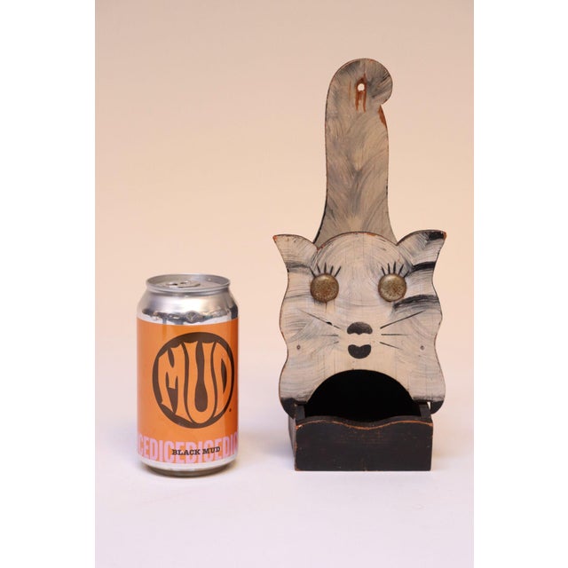 Hand-carved Folk Art matchbook holder with attached metal eyes and original hand-painted details (ca. 1940s, USA). Primary...